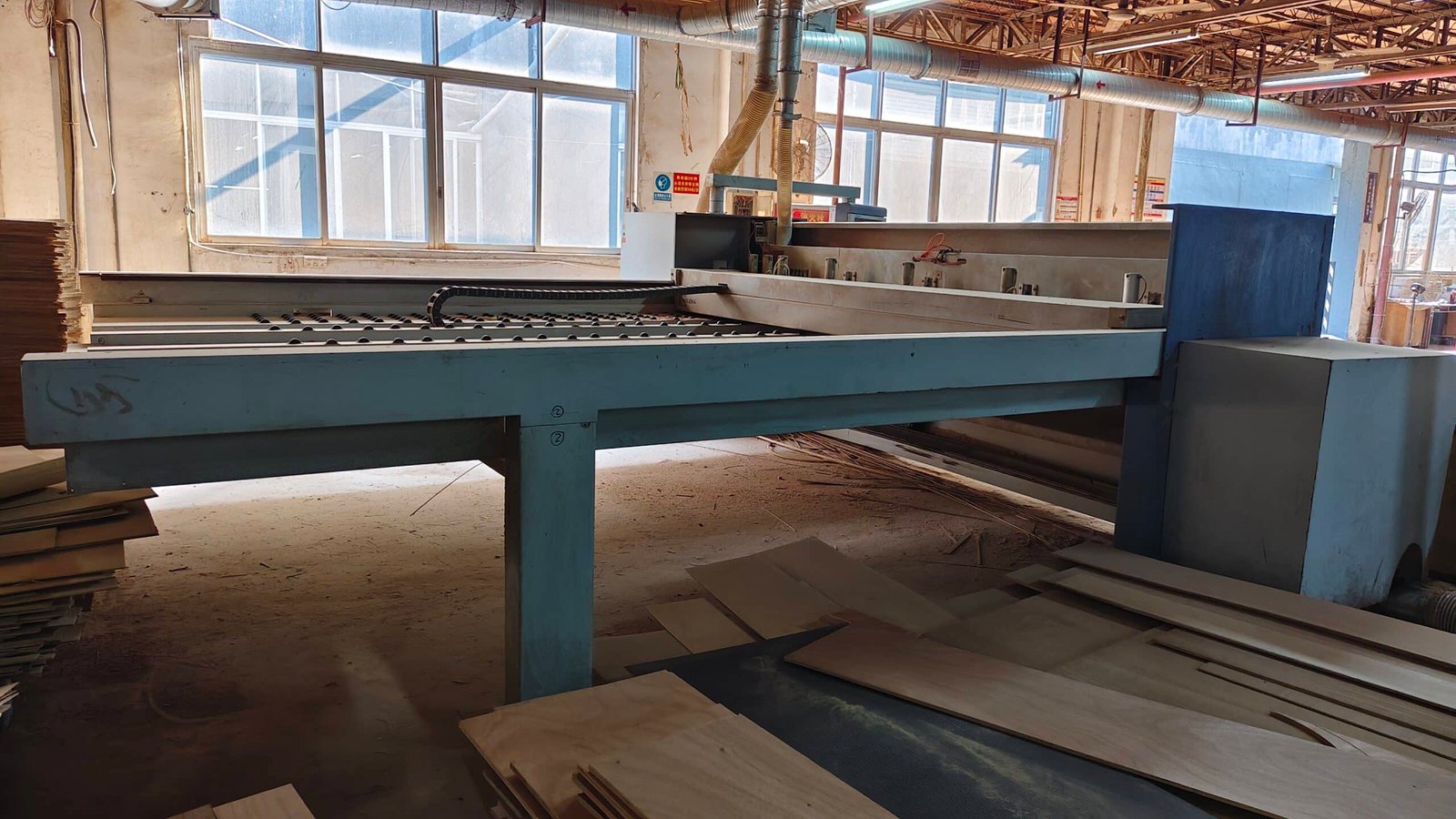 CNC joinery machine cutting E0 plywood for custom hotel room furniture